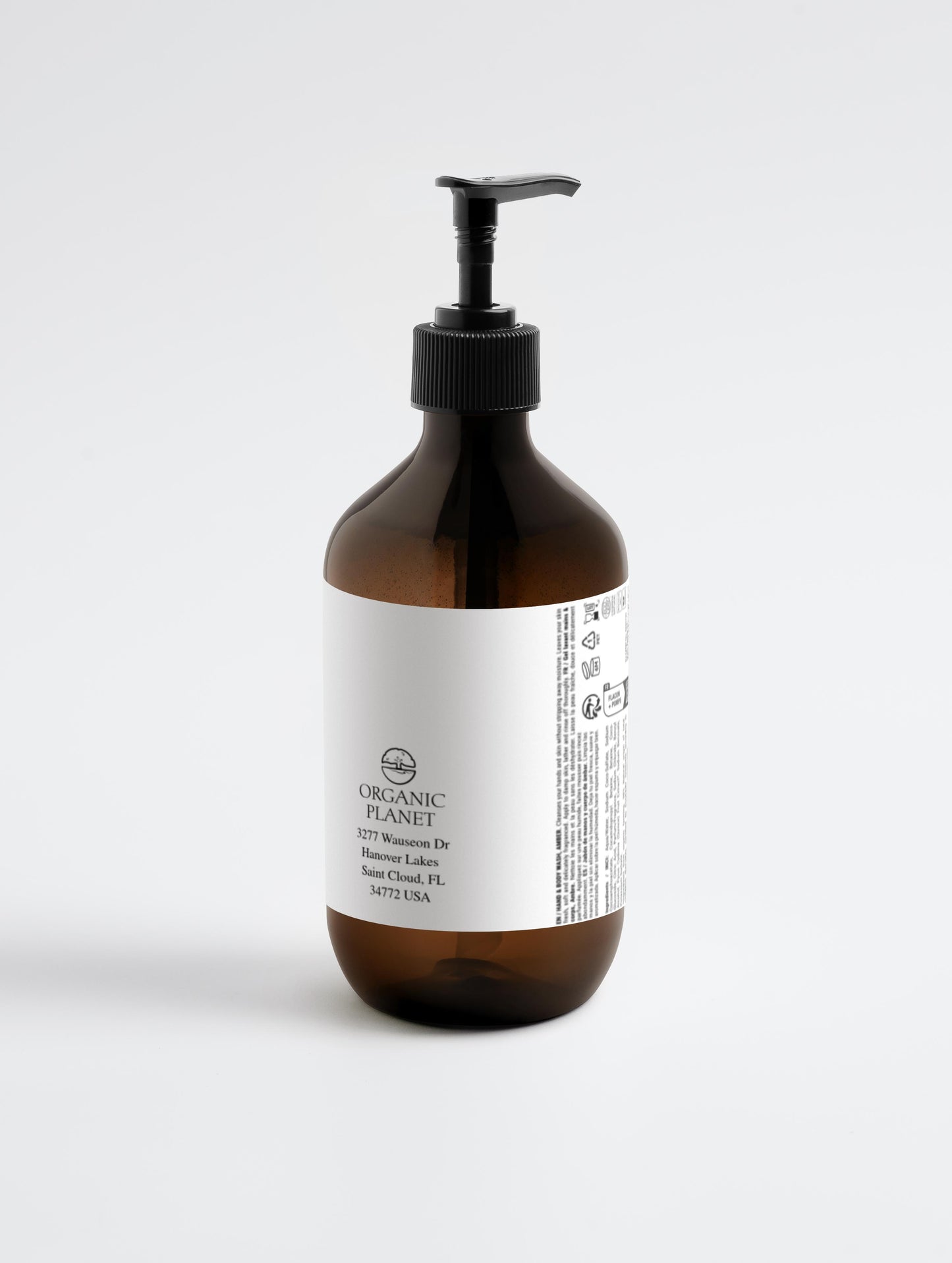 Brown bottle with pump and white label on a light gray background.