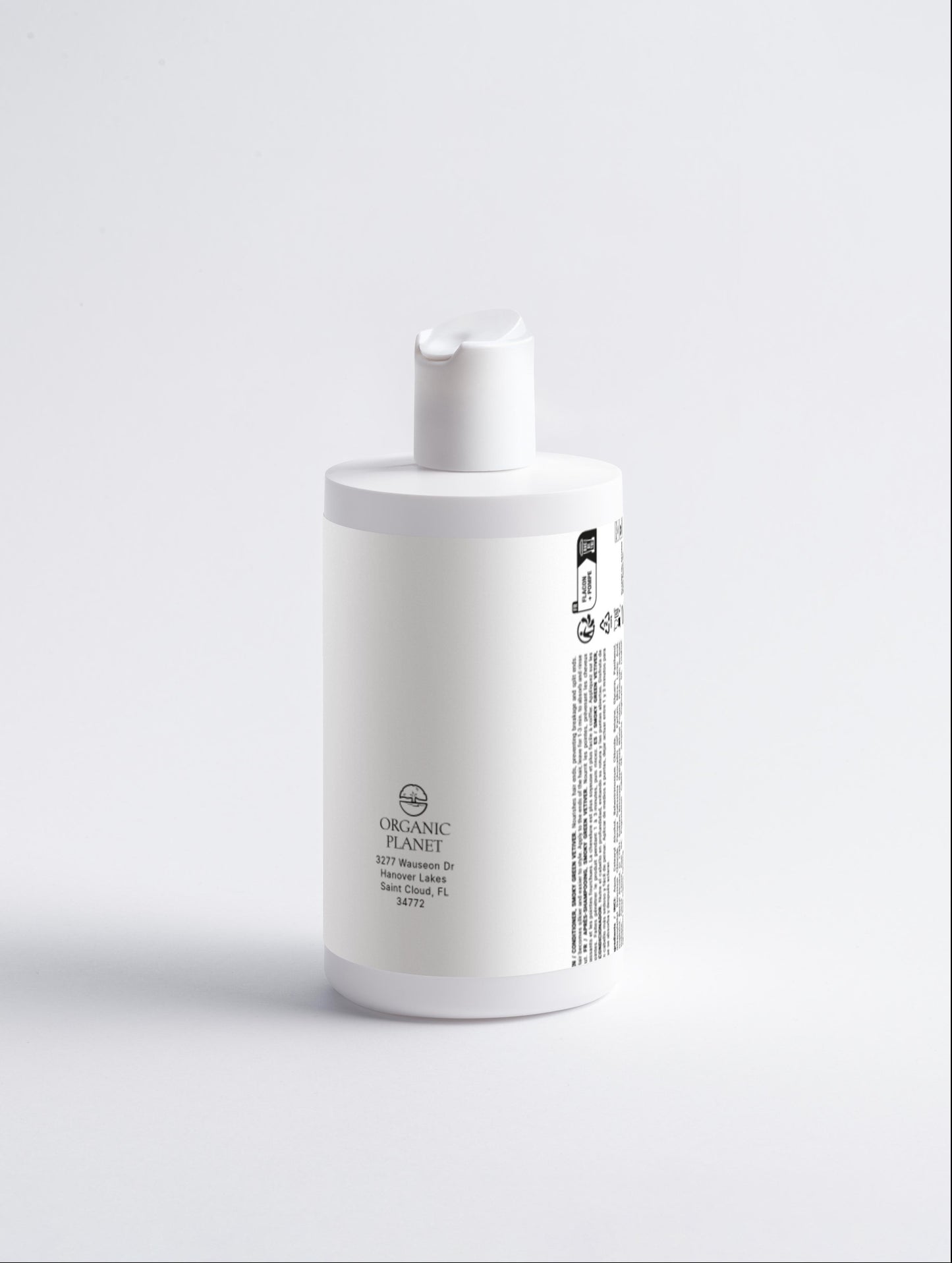 White bottle with a label on a light gray background