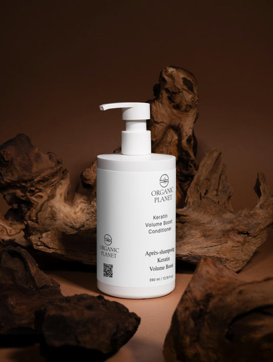 White bottle of Organic Planet conditioner on a brown background with organic elements.